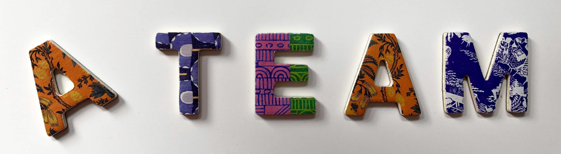 TEAM spelled with wooden blocks, symbolizing collaboration